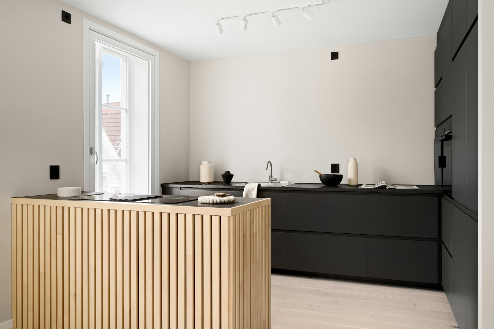 A kitchen with a wooden counter top next to a window
